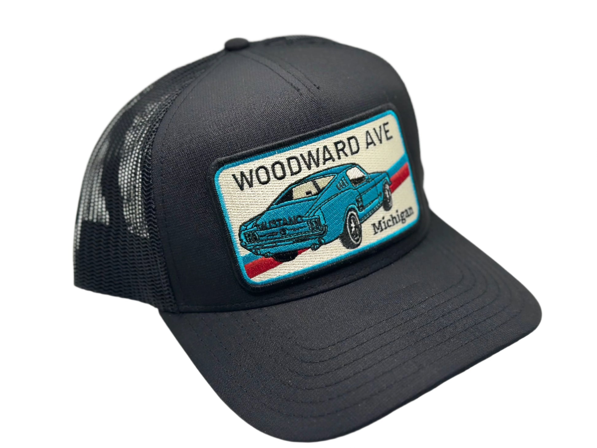 Black trucker hat with a patch featuring a blue car and 'Woodward Ave, Michigan' text on a white background.
